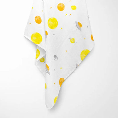 close-up of white bamboo baby blanket texture showing soft weave and vibrant celestial pattern