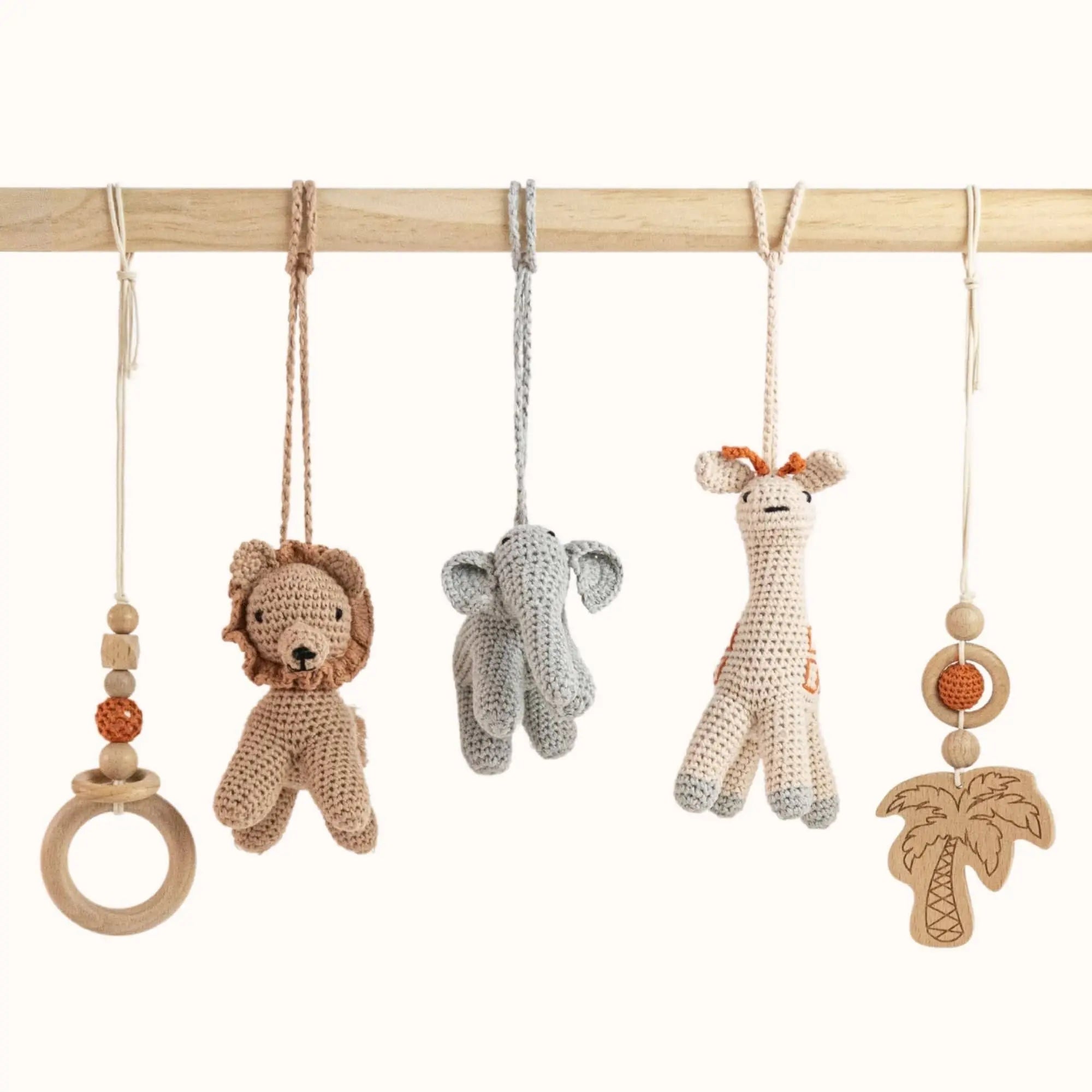 Close-up of Wild Jungle Play Gym toys showing detailed crochet lion, elephant, giraffe, wooden palm tree and beaded ring