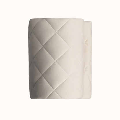 Detailed view of grey quilted vegan playmat texture providing soft contrast to natural wooden toys