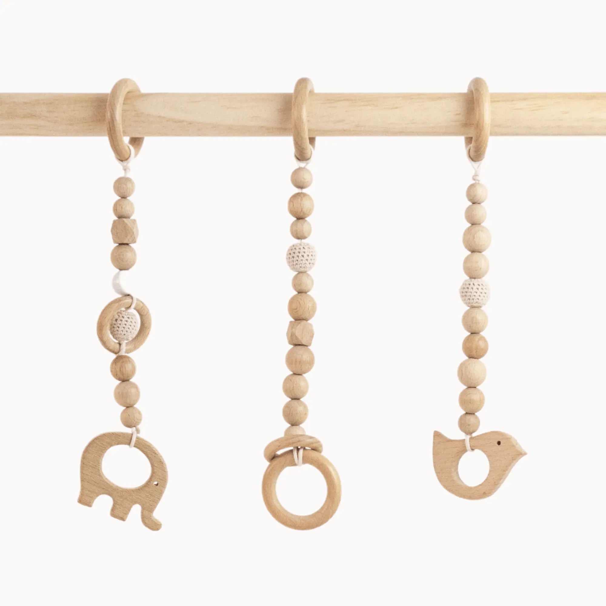 Close-up of Wooden Animals Play Gym toys showing detailed wooden elephant, bird carvings and smooth wooden ring with natural bead strands